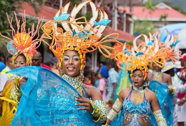 Victoria, Seychelles, Annual international Carnival. Victoria, Seychelles - February 9, 2013:  A group of Female dancers in beautiful blue and green outfit performing on streets of Victoria, on Parade of Seychelles international Carnival mahe island stock pictures, royalty-free photos & images