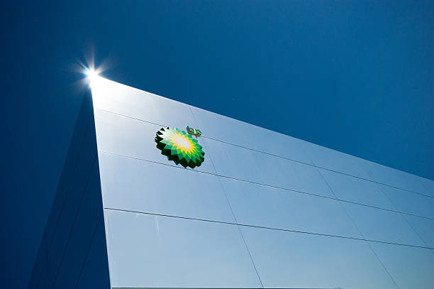 London Olympics BP Building Modern Architecture London, England - September 7, 2012: London Olympics BP venue. This is a view of the corner against a deep blue sky, it shows the clean mirrored lines and the styling of this unique building together with teh BP logo and a lens flare on the very corner of the building. 2012 stock pictures, royalty-free photos & images