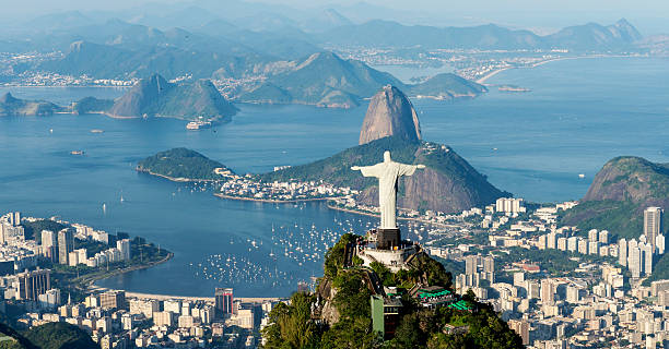 Rio de Janeiro Rio de Janeiro, Brazil - June 6th, 2013: Aerial view from a helicopter of the city of Rio de Janeiro with the Corcovado mountain and the statue of Christ the Redeemer with Sugarloaf mountain in the background. cristo redentor rio de janeiro stock pictures, royalty-free photos & images