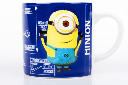 Mexico City, Mexico- August 24, 2013: Close up of a small ceramic Minion mug, from the Despicable me computer animated comedy film. Object isolated on white background