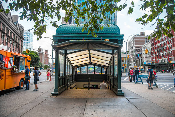 New York City, NY, USA - August 2, 2013:  The 6 train subway station at Astor Place in Manhattan with pedestrians visible. Completed in 1904 station is one of the original 28 in the New York City subway system and is a Registered Historic Place.