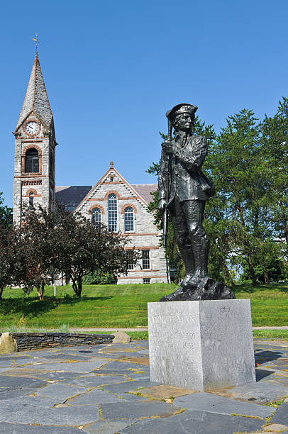 Minuteman Amherst, Massachusetts, USA-July 14, 2013: The statue "Minuteman" stands on a granite block in front to the Old Chapel (1884) on the campus of the University of Massachusetts. university of massachusetts amherst stock pictures, royalty-free photos & images