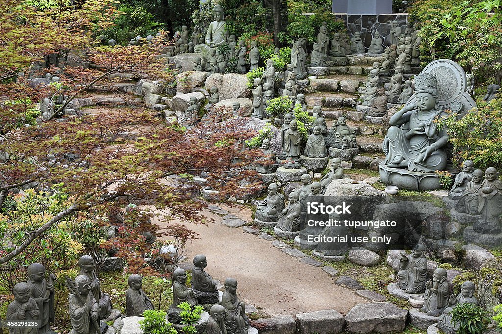 Japan Miyajima, Japan - April 21, 2012: View of Ksitigarbha statues in Daisho-in Buddhist temple on the island Miyajima in Hatsukaichi (Hiroshima prefecture, region Chugoku). It is part of Miyajima's famous UNESCO World Heritage Site. Architecture Stock Photo