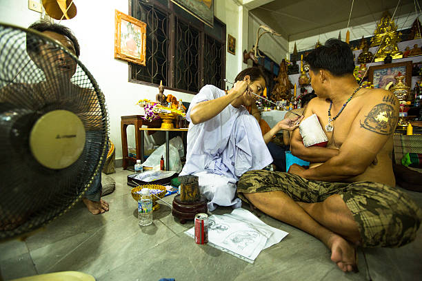 Nakhon Chai, Thailand - March 23, 2013: Unidentified monk makes traditional Yantra tattooing during Wai Kroo Master Day Ceremony in Wat Bang Pra.