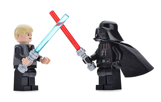 Lego Darth Vader vs Luke Skywalker Ankara, Turkey - April 06, 2013: Close- up of a Lego Star Wars Darth Vader and Luke Skywalker are fighting with sword isolated on white background. star wars stock pictures, royalty-free photos & images