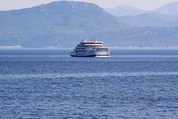 At Adriatic Sea, Croatia - September 4, 2011: A car ferry of the operator Jadrolinija, carrying passengers and cars, is traveling in the Adriatic Sea near the Croatian island KorAula.