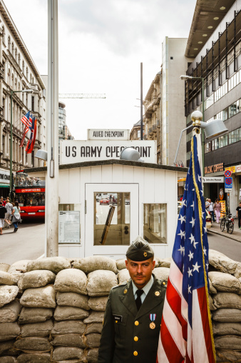 Berlin, Germany - September 7, 2009: A man posing as American soldier at Western Allies's Checkpoint Charlie \