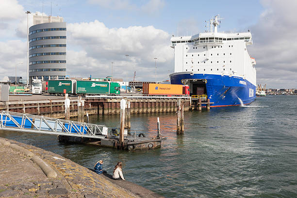 IJmuiden, the Netherlands - April 1, 2012 : Children in the harbor of IJmuiden watching cargo being loaded on the ferry \