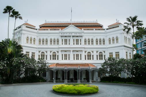 Singapore, Singapore City - June 3, 2013: The white front faAade of the Raffles Hotel, a colonial-style hotel in Singapore.