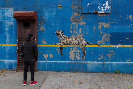 Bansky's Better Out than In - An artist residency on the streets of New York. British artist ,Bansky, placed his work on a wall outside of a closed business on the corner of 162nd street and Jerome Avenue in the Bronx in front of Yankee Stadium.