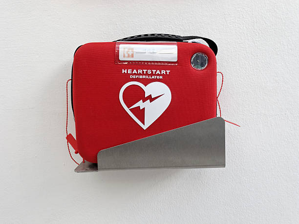 Defibrillator Nuremberg, Germany - November 3, 2013: Red heartstart external Defibrillator hangs on a white wall in a museum in Germany, Nuremberg. defibrillator photos stock pictures, royalty-free photos & images