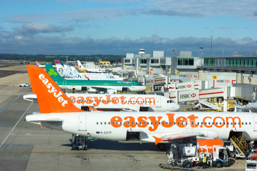 London, UK - August 30, 2013: A view of an Easyjet plane at the boarding park at Gatwick Airport in the county of Surrey. Easyjet is a British airline carrier. HSBC Bank logos are in the background.