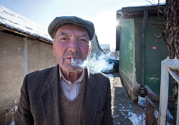 Old man smoking cigar stock photo