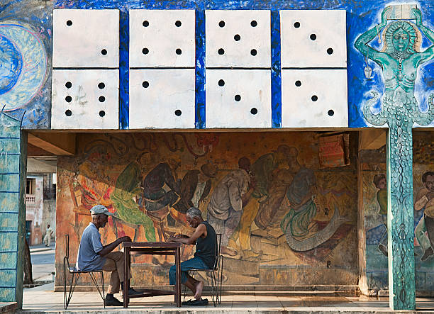 Santiago de Cuba, Cuba - April 12, 2009: Old men playing dominoes on the patio of an old painted house in Santiago de Cuba, Cuba on April 12, 2009. The domino game is the most widespread and practiced in Cuba.