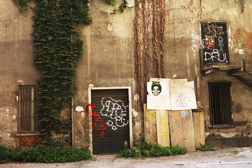 Milan, Italy - October 3, 2011: Backyard with green ivy and graffiti by  the fashionable shopping street Corso Como in Milan, Italy