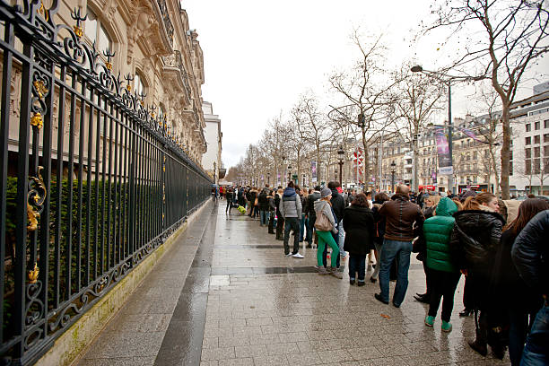 People waiting in line near Abercrombie & Fitch Shop, Paris Paris, France - December 27, 2012: People waiting in line to enter the  Abercrombie & Fitch Shop, located on Champs-ElysAes, Paris abercrombie fitch stock pictures, royalty-free photos & images