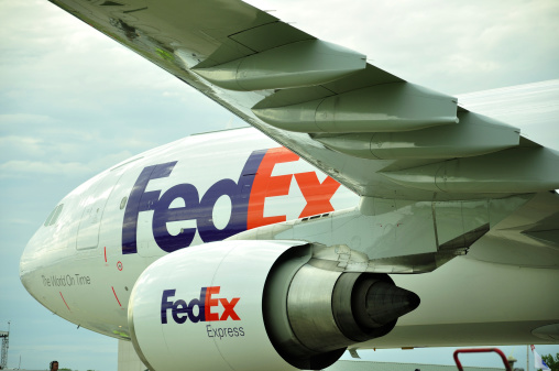 Oshkosh, WI, USA - July 31, 2013: FedEx Express global airfreight jet parked at Oshkosh EAA AirVenture fly-in, 10 minutes prior to take off.