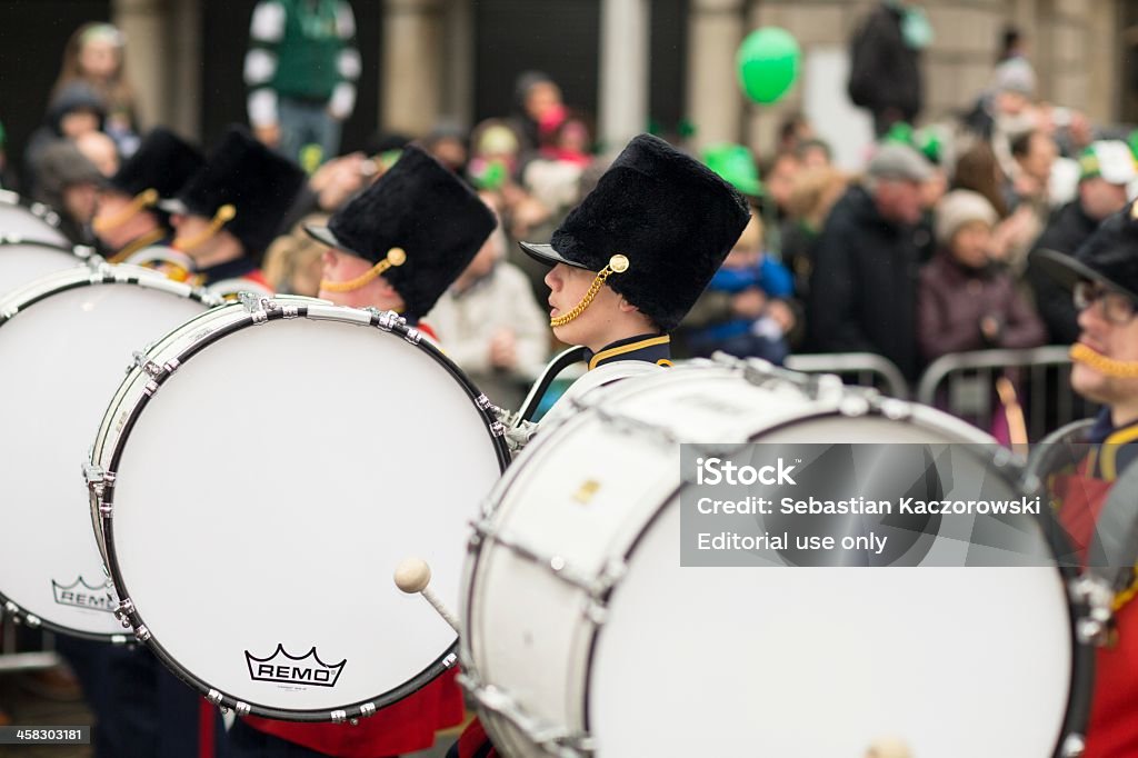 young bass drummers in one row marching Dublin, Ireland - March 17, 2013: Young bass drummers in one row marching during St. Patrick's Day Parade Drum - Percussion Instrument Stock Photo