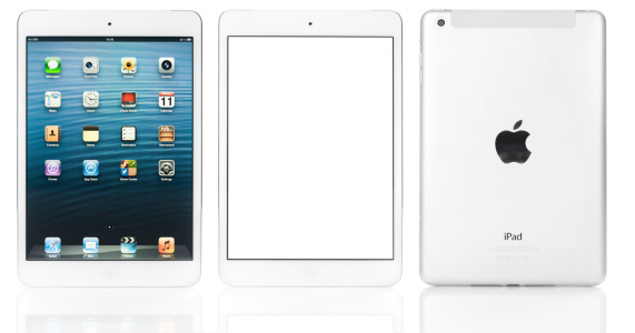 Berlin, Germany - February 11, 2013: Close-up of an Apple iPad mini white showing three different versions: iPad showing home scree, showing, blank screen and the back side. Shot on white background. The iPad mini, a smaller, thinner version of the iPad and has a 7.9\