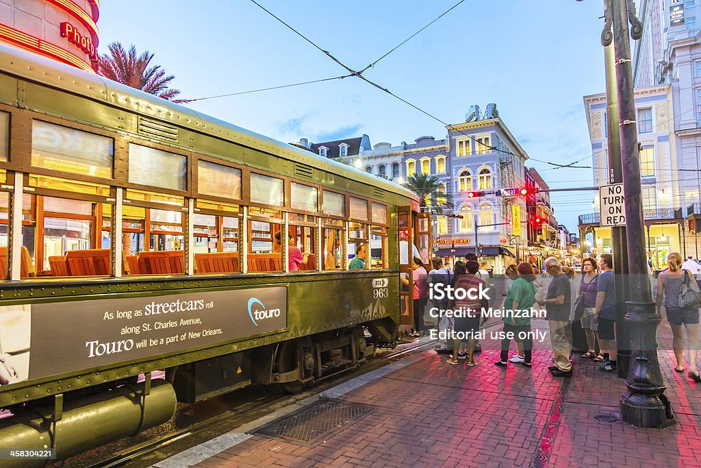 people travel with the famous old Street car New Orleans, USA - July 14, 2013:  people travel with the famous old Street car St. Charles line in New Orleans, USA.  It is the oldest continually operating street car line in the world. Cable Car Stock Photo