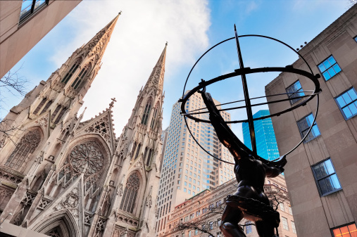 New York City, New York, USA - December 30, 2011: Fifth Avenue street view with Atlas statue and St Patrick Cathedral.