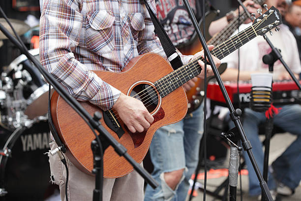 Guitarist and band play outside Hank's Saloon in Brooklyn stock photo