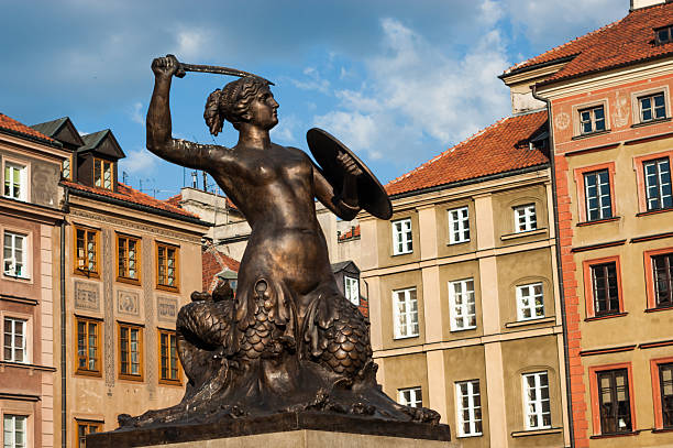 Warsaw, Poland - May 26, 2012: Statue of mermaid holding sword and bucket (Siren) statue on Warsaw old town. Mermaid is a Warsaw city symbol. Sirens duty is to protect capital of Poland