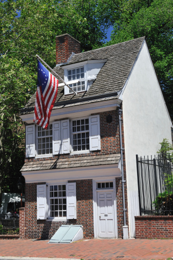 Philadelphia, USA - May 20, 2012. Historic Betsy Ros House on Arch Street with three people in courtyard on left. Philadelphia is the largest city in Pennsylvania with historic landmarks like Betsy Ross House, Independence Hall and Liberty Bell, which attracts lots of visitors from the country and around world.