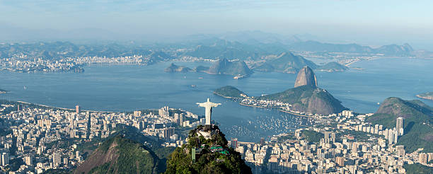 Rio de Janeiro Rio de Janeiro, Brazil - June 6th, 2013: Aerial view from a helicopter of the city of Rio de Janeiro with the Corcovado mountain and the statue of Christ the Redeemer with Sugarloaf mountain in the background. cristo redentor rio de janeiro stock pictures, royalty-free photos & images