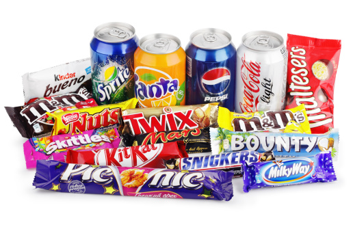 Tula, Russia - December 13, 2012: Large collection of junk food isolated on white with clipping path. Includes Coca Cola, Pepsi, Fanta, Sprite, Skittles, Snickers, Kit Kat, Twix, Bounty, Mars, Milky Way, Picnic, Nuts, Kinder Bueno, Maltesers, M+M's.