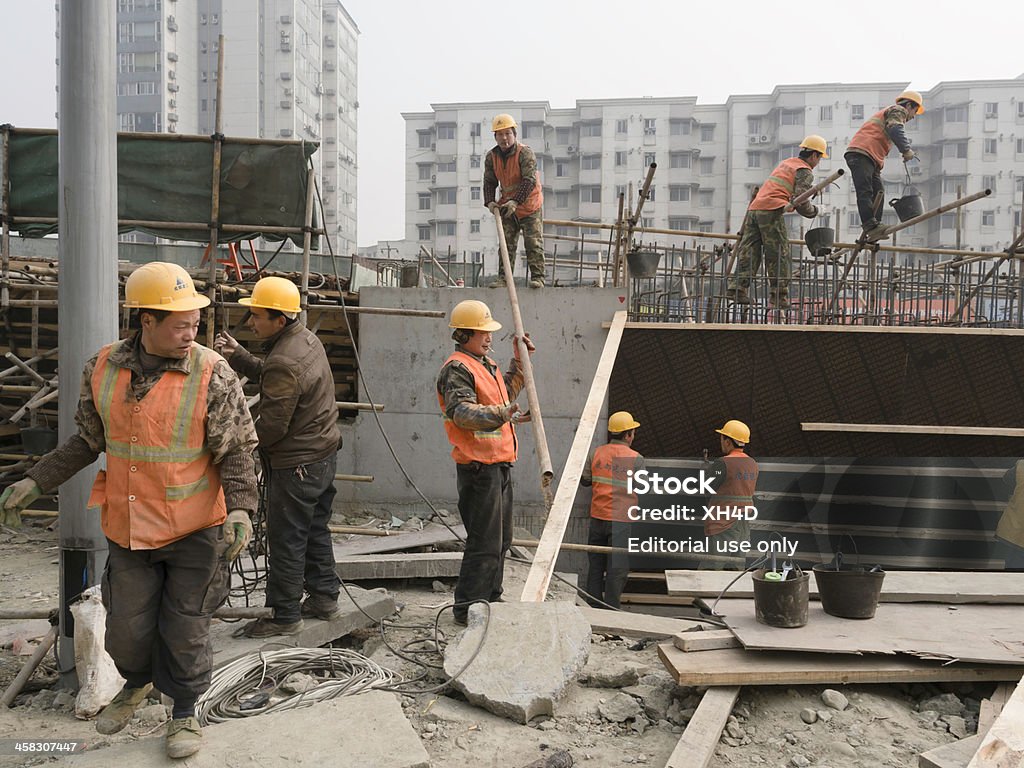 Building in china Chengdu, China - January 17, 2013: The migrant workers are building flyovers to alleviate the gridlock in ChengDu Chuang Ye Road, but the dust brings the big fog to cause huge pollution. Adult Stock Photo