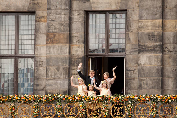 Amsterdam, The Netherlands - April 30,2013:Queen Maxima and children waves from the balcony of the palace after the accession of the throne.