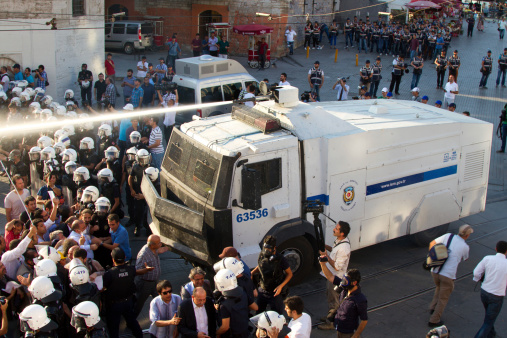 Istanbul, Turkey - July 06, 2013: Riot Control Vehicle interfere with water cannon to protestors. People are protesting the prohibition of entry to Gezi Park since 15 June 2013