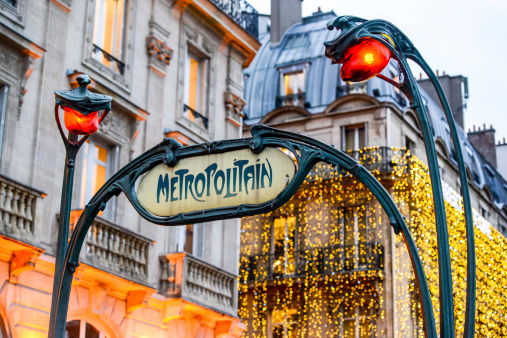 Paris, France  - December 28, 2012: Paris Metro Sign with beautiful Christmas lights decoration on building on background