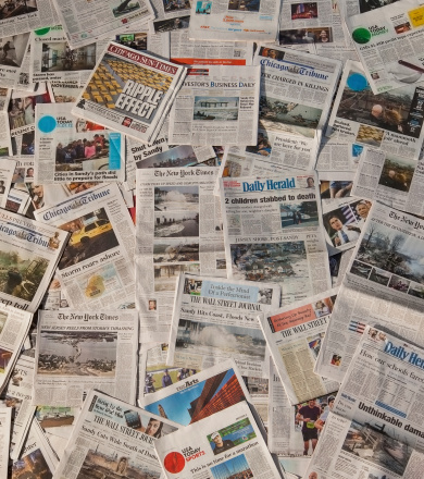 Carol Stream, IL, USA - November 4, 2012: A pile of local and national newspapers, many of them with headlines on the front pages reporting stories in the days immidiatley following the impact of hurracaine / superstorm sandy after it hit the East Coast of the USA.