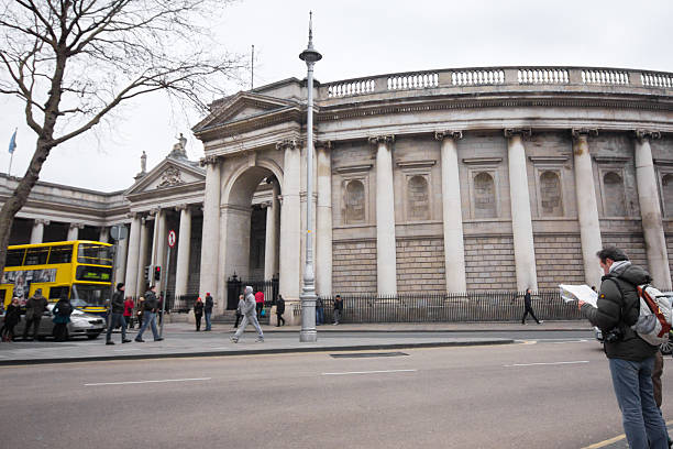Dublin, Ireland - April 1, 2013: The circular screen wall at landmark Bank of Ireland in Dublin on April 1, 2013 with visitors in view.  Once serving as Irish Parliament House this historic building is now The Bank of Ireland College Green.