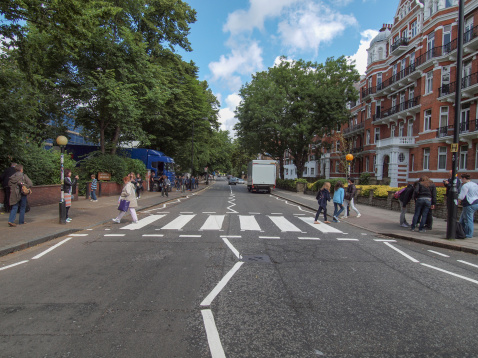 London, England, UK - June 18, 2011: People crossing the Abbey Road zebra crossing made famous by the 1969 Beatles album cover