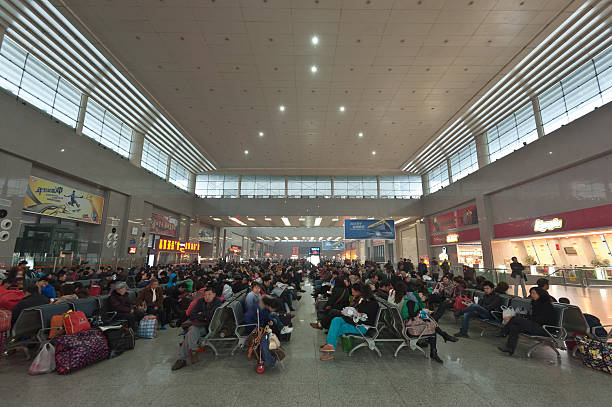 Wuchang, China - November 21, 2012: Passengers were waiting for a train in the waiting hall.Wuchang Railway Station is located in Wuchang District, Wuhan, Hubei, China,it was built in 1916, the station was moved several times and settled in the current location on 1957.It is the largest  railway station in the middle of Beijing-Guangzhou line, with daily traffic of 77,000 passengers.