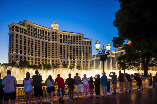 Las Vegas, USA - September 21, 2013: People on the Las Vegas strip stop to enjoy the musical dancing fountains outside the Bellagio Hotel and Casino at night.
