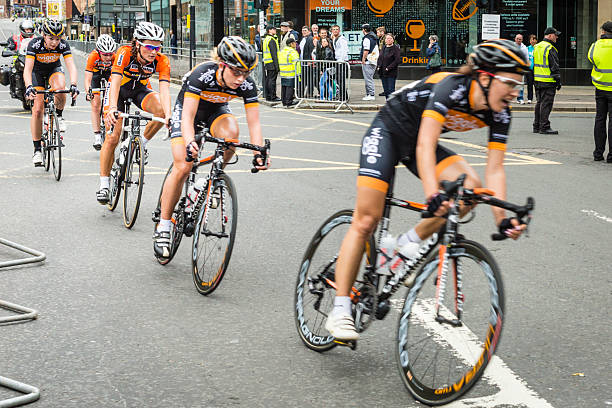 2013 British National Road Race Cycling Championship, Glasgow Glasgow, UK - June 23, 2013: Spectators watch as the leading pack of five cyclists pass in the women's event of the British National Road Race Championship.British National Road Race Championship is an annual bicycling competition administered by the British Cycling Federation. In 2013 the event was held on the streets of Glasgow city centre for the first time.The race was won by Lizzie Armistead, third in this pack; runner-up was Laura Trott, second in this pack; third was Dani King, leading the pack at this point. st george street stock pictures, royalty-free photos & images