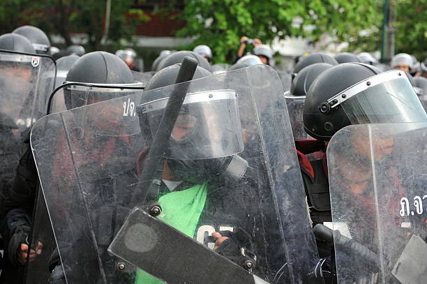 Bangkok, Thailand - November 24, 2012: Riot Police stand guard on Makhawan Bridge during a large anti-government rally organised by the nationalist Pitak Siam group.