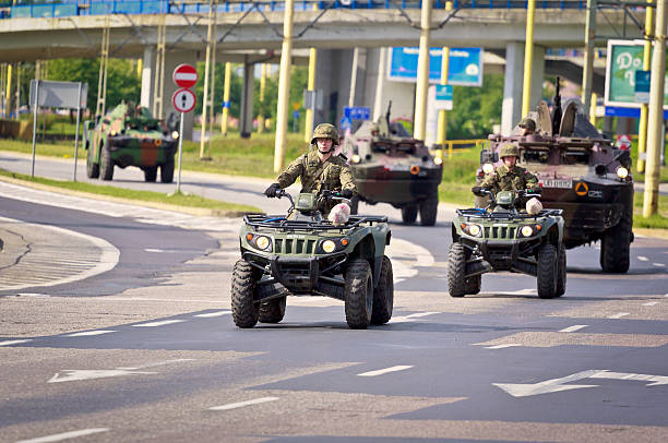 Szczecin, Poland - May 28, 2011: Polish Army  in  camouflage vehicles on the Parade on public streets of Szczecin, Poland. Two military qoads on foreground