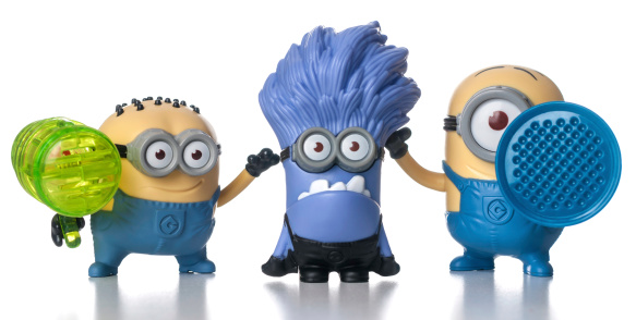 Miami, USA - July 22, 2013: Set of Minions McDonalds happy meal toys includes Jerry Whistle, Purple Minion Giggling and Suart Blaster. These are plastic toy sold as part of the McDonald's Happy Meals.