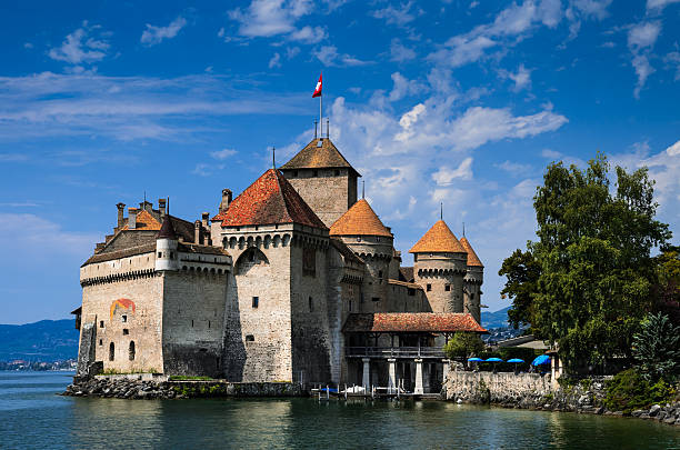 Chateau de Chillon on Lake Geneva, Switzerland Montreaux, Switzerland - August 18, 2011:  This is a photograph of Chillon Castle (Chateau de Chillon) on the shores of Lake Geneva near Montreux taken on a summer day. The first written record of the castle is in 1160 and today is opened for tourist visits. chateau de chillon photos stock pictures, royalty-free photos & images