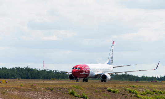 Stockhom, Sweden - June 14, 2012: A Norwegian Air Shuttle Boeing 737-800 taxiing on the runway after landing at Arlanda Airport, Sweden. Norwegian Air Shuttle, commercially branded 