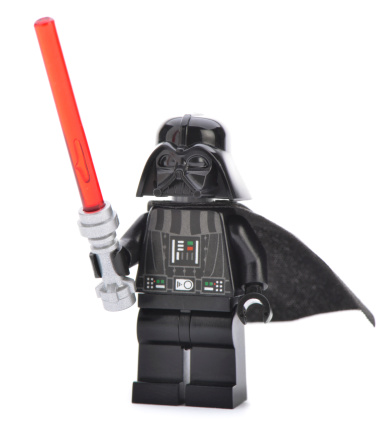 Ankara, Turkey - April 06, 2013: Close- up of a Lego Darth Vader minifigure with sword isolated on white background.