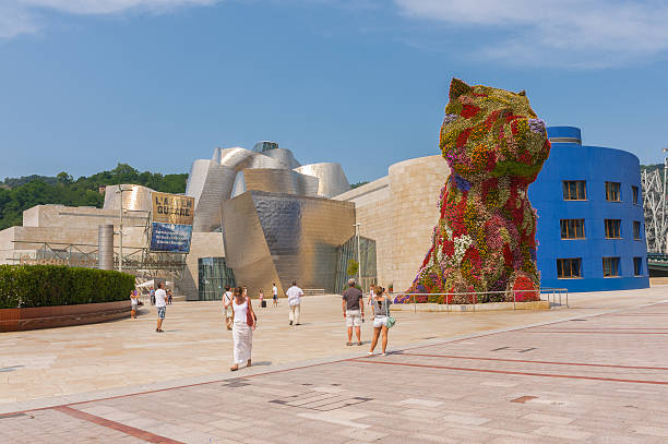 Bilbao, Spain - July 19, 2013: Guggenheim Museum and Puppy sculpture on July 19, 2013 in Bilbao, Spain. The museum was designed by Frank Ghery and the Puppy sculpture by Jeff Koons