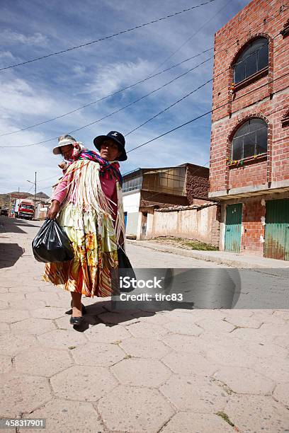 Bolivian Woman In Traditional Dress Carrying Child On Back Stock Photo - Download Image Now