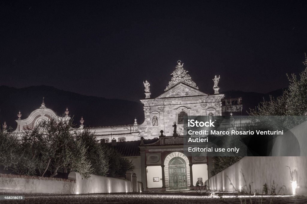 National Museum of the Monumental Charterhouse of Pisa, night view Calci, Italy - July 17, 2013: the Museo Nazionale della Certosa Monumentale di Pisa, also called "Certosa di Calci", is illuminated at night. The latin inscription "O beata solitudo, o sola beatitudo" means "Peaceful solitude only beauty". The poster bears the name of the place ("Certosa").  Ancient Stock Photo