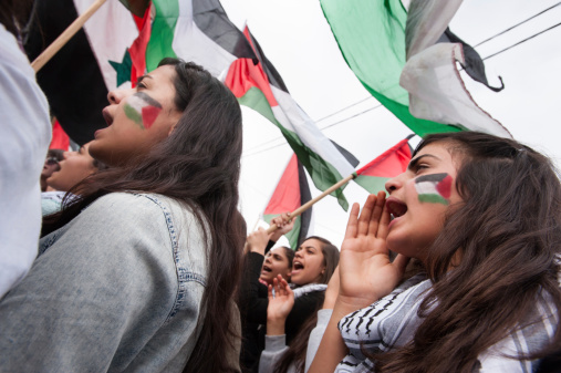 Sakhnin, Israel - March 30, 2013: Palestinian youth from the Galilee town of Sakhnin chant slogans during a Land Day demonstration, March 30, 2013. Land Day commemorates the death of six Palestinian protesters at the hands of Israeli forces during mass demonstrations in 1976 against plans to confiscate Palestinian land in northern Israel.
